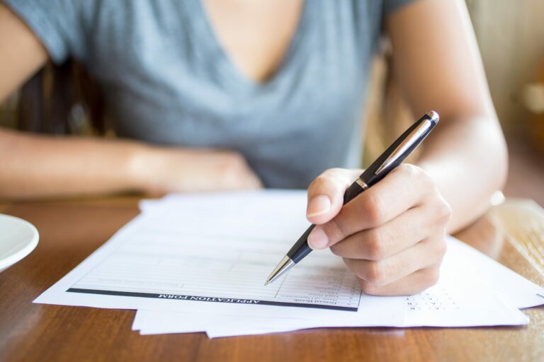 close up of woman filling application form scaled 1